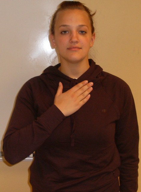 ASL sign for my: flat hand pressed against the chest, palm facing in