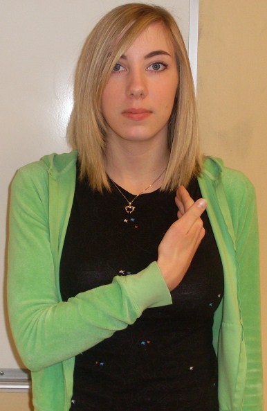ASL sign for our, step 2: flat hand swung to the left side of the chest