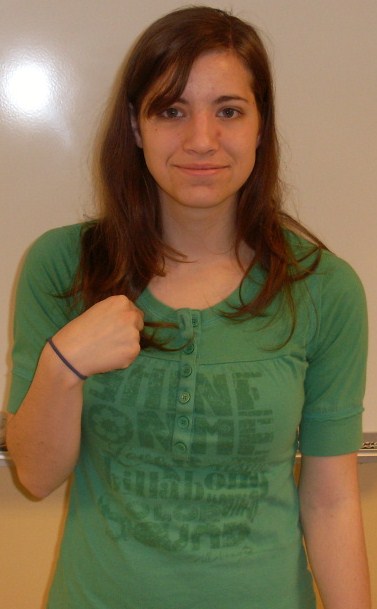 ASL sign for us, step 1: index finger pointing to one side of the chest