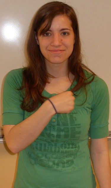 ASL sign for us, step 2: index finger swung to the other side of the chest